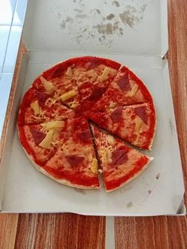 Sliced ​​pizza in a box on the table Stock Photos