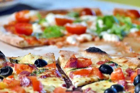 Sliced pizza, close up view Stock Photos