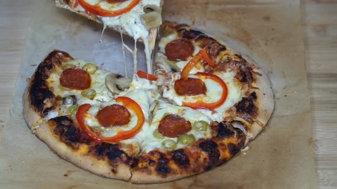 Sliced pizza lifted on a spatula Stock Footage 105200421