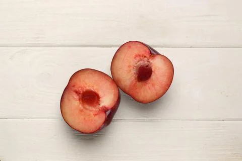 Sliced plum on the table. Close up. White background Stock Photos