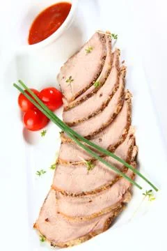 Sliced pork baked in an oven with spices Stock Photos
