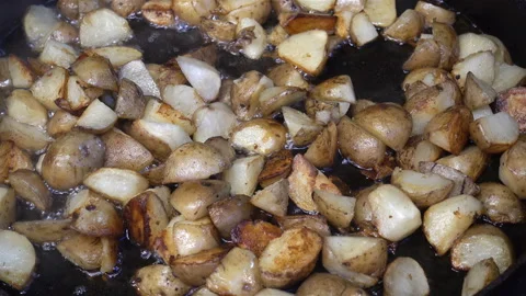 Sliced potatoes are fried in boiling oil in 4K. Stock Footage 124115736