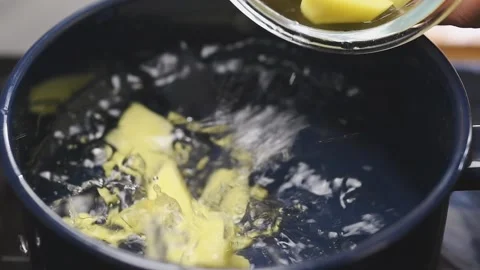 Sliced potatoes falling into water. Stock Footage 154937406