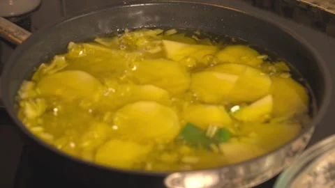 Sliced potatoes frying in bubbling olive oil Stock Footage 331314035