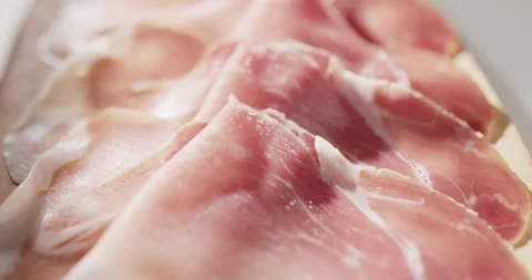 Sliced prosciutto on cutting board Stock Footage 319402044
