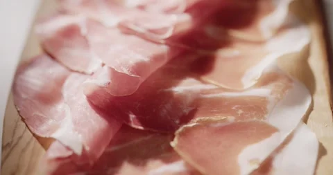 Sliced prosciutto on cutting board Stock Footage 319402046