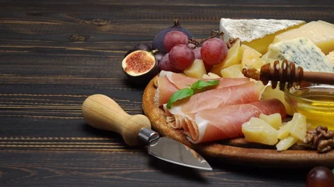 Sliced prosciutto or jamon meat and cheese on concrete background Stock Footage 89754641