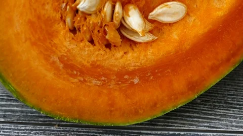 Sliced pumpkin and kernels, natural organic pumpkin in orange color, 動画素材 101062858