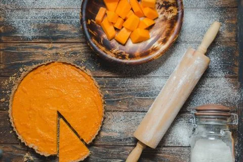 Sliced pumpkin pie on a table Stock Photos