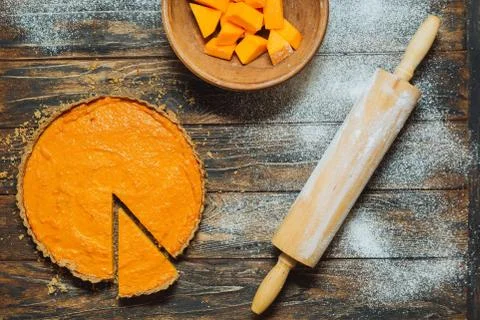 Sliced pumpkin pie on a table Stock Photos