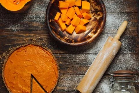 Sliced pumpkin pie on a table Stock Photos