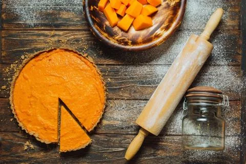 Sliced pumpkin pie on a table Stock Photos