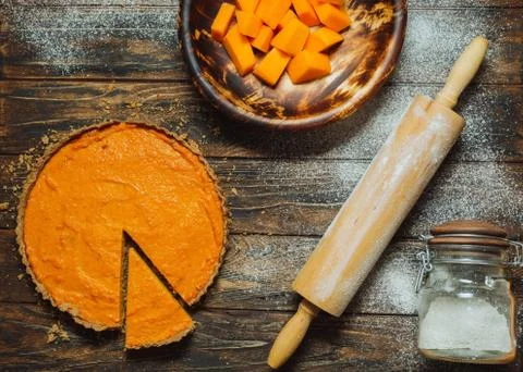 Sliced pumpkin pie on a table Stock Photos