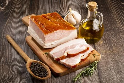 Sliced ??raw bacon on the table. Stock Photos