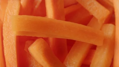 Sliced raw carrots super close up slowly rotating stock footage Stock Footage 142666825