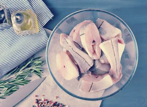 Sliced raw fish of the cod in a deep bowl - top view Stock Photos