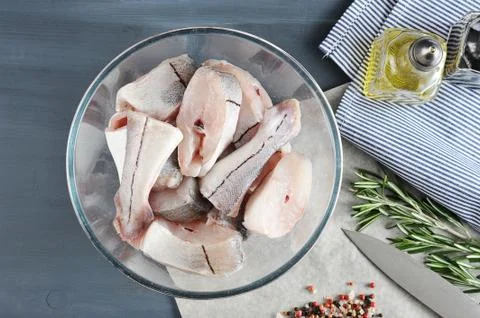 Sliced raw fish of the cod in a deep bowl - top view Stock Photos