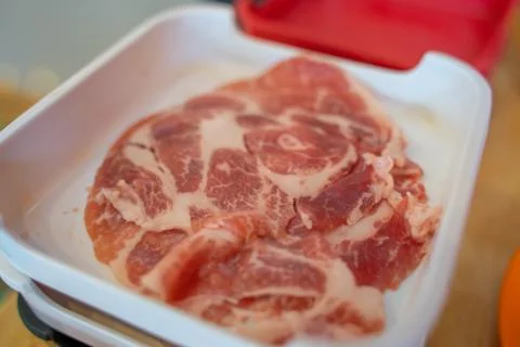 Sliced raw pork meat isolated on white background. Top view. Flat lay Stock Photos