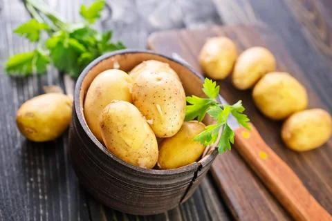 Sliced raw potato on the kitchen table Stock Photos