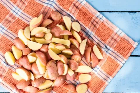 Sliced raw potatoes drying  on the kitchen tablecloth Stock Photos