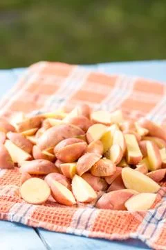 Sliced raw potatoes drying  on the kitchen tablecloth Stock Photos