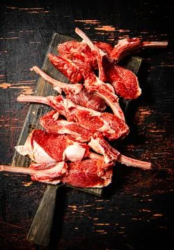 Sliced raw rack lamb. Against a dark background. Stock Photos
