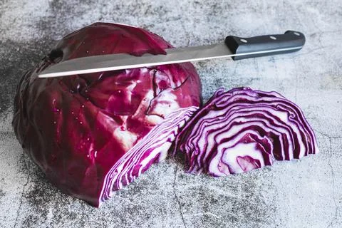 Sliced raw red cabbage with a kitchen knife Stock Photos