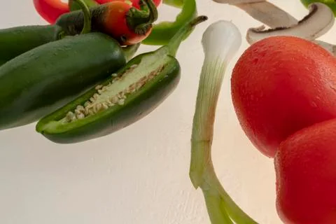 Sliced raw vegetables on white background Stock Photos