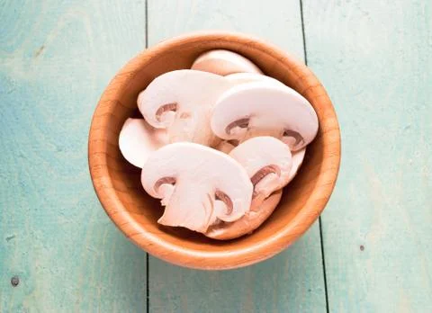 Sliced raw white champignons preparing for cooking Stock Photos