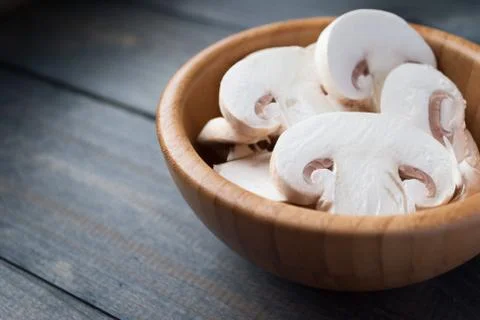 Sliced raw white champignons preparing for cooking Stock Photos