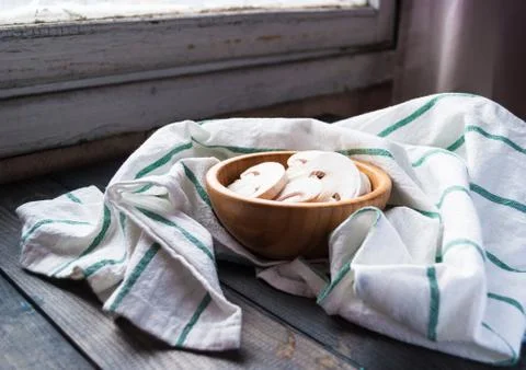 Sliced raw white champignons preparing for cooking Stock Photos