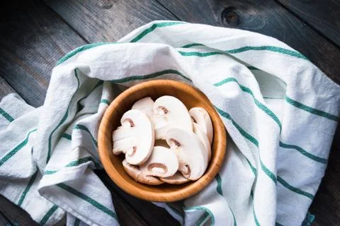 Sliced raw white champignons preparing for cooking Stock Photos