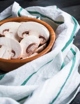 Sliced raw white champignons preparing for cooking Stock Photos