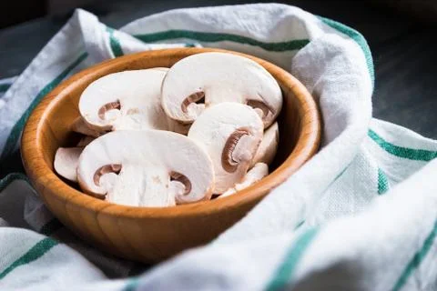 Sliced raw white champignons preparing for cooking Stock Photos