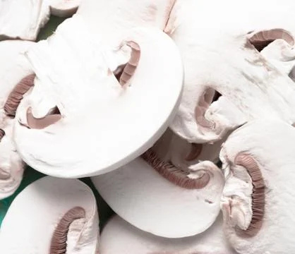 Sliced raw white champignons preparing for cooking Stock Photos