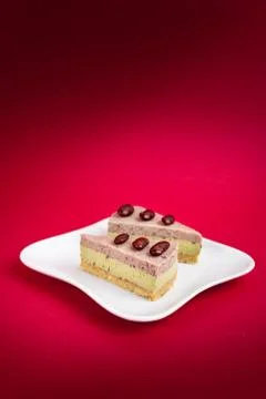 Sliced of Red bean cheese cake on white plate on red Background. Foto stock