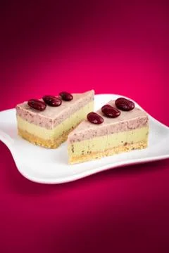 Sliced of Red bean cheese cake on white plate on red Background. Foto stock