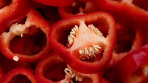 Sliced Red Bell Pepper (Cappie) Spinning on Dark Surface. Top-Down Vibrant Loop Stock Footage 325648086