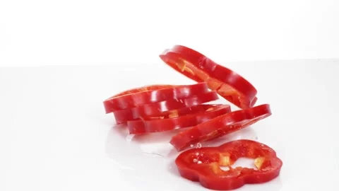 Sliced red bell pepper rings falling in slow motion Stock Footage 147378210