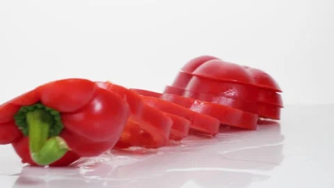 Sliced red bell pepper rings falling in slow motion Stock Footage 147378221