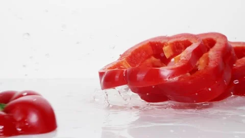 Sliced red bell pepper rings falling in slow motion Stock Footage 147378222