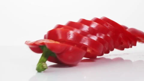 Sliced red bell pepper rings falling in slow motion Stock Footage 147378226