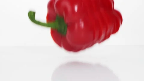 Sliced red bell pepper rings falling in slow motion Stock Footage 147378228