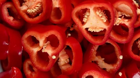 Sliced Red Cappie Pepper Spinning on Dark Surface. Top-Down Seamless Loop 스톡 동영상 326181808