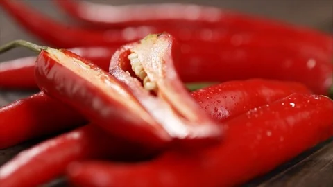 Sliced Red Chili Pepper Falling onto other ones Closeup Stock Footage 99138438