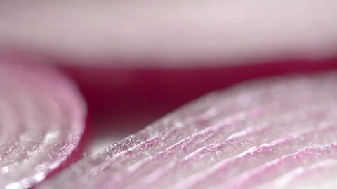 Sliced red onion rings rotating on white in 4K. Closeup top view of healthy food Stock-Footage 126022100
