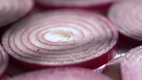 Sliced red onion rings rotating on white in 4K. Closeup top view of healthy food Stock Footage 126264450