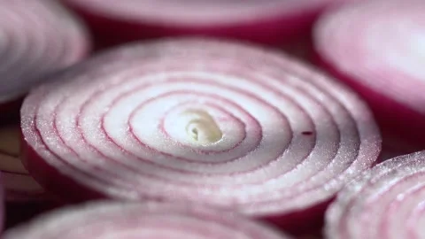 Sliced red onion rings rotating in 4K. Closeup top view of healthy food Stock Footage 149184156