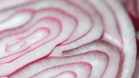 Sliced red onion rings rotating in 4K. Closeup top view of healthy food Stock Footage 151152385