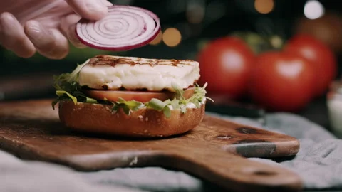 Sliced Red Onions Being Placed On Halloumi  With Tomato and Rocket Video stock 134403914